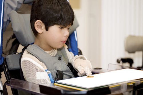 Five year old disabled boy studying in wheelchair